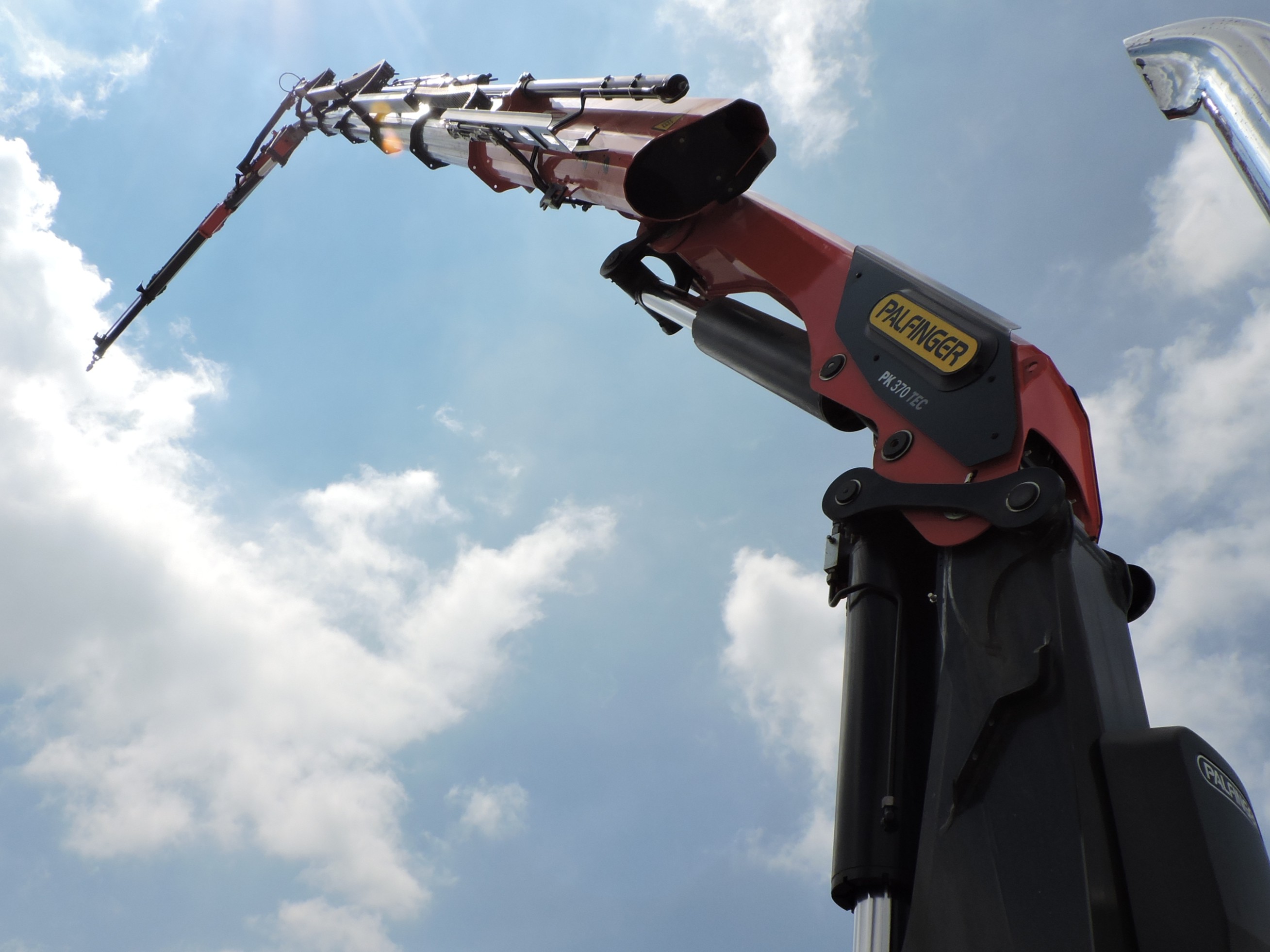 Skyward view of Palfinger crane boom