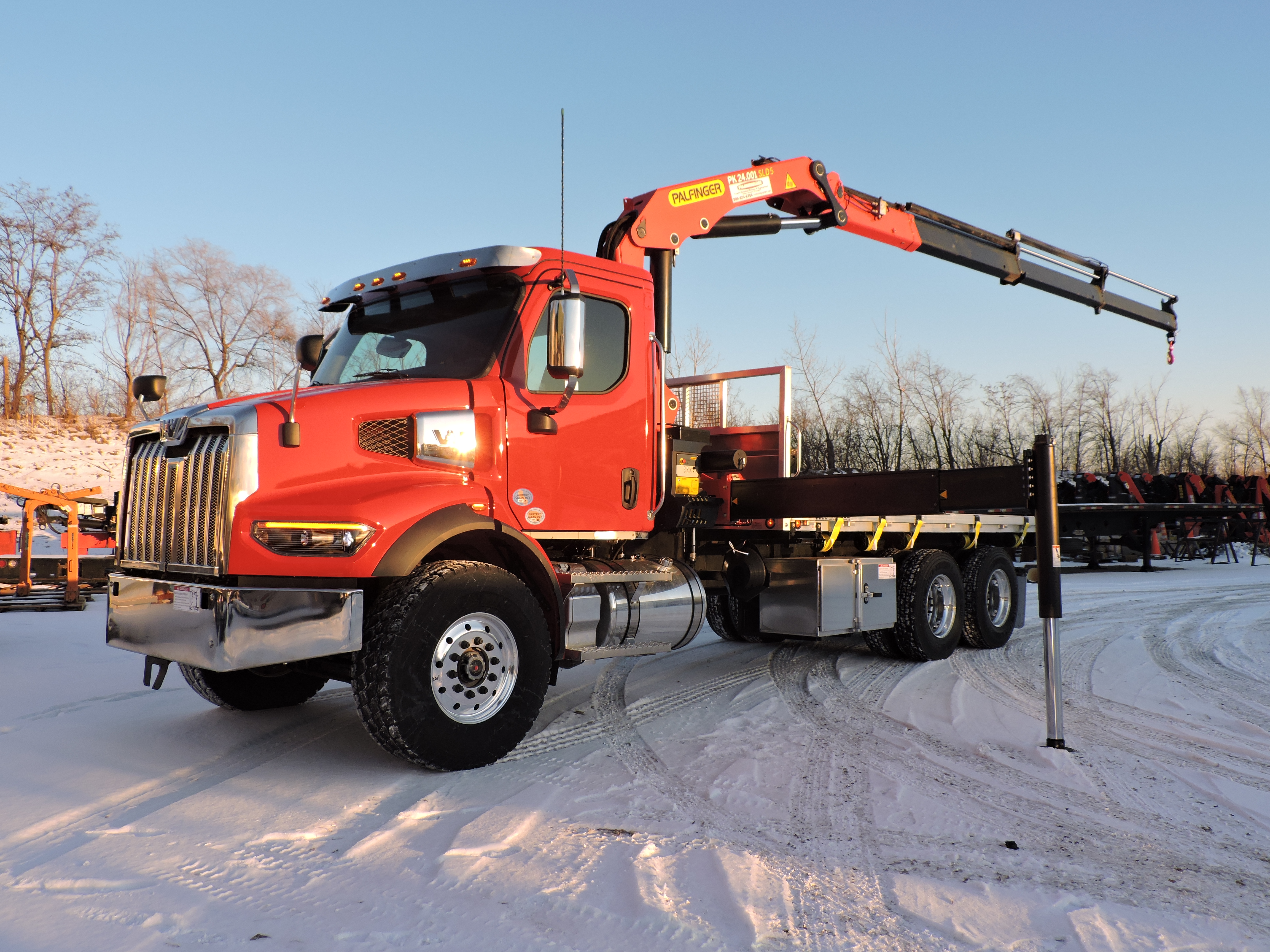 Red Palfinger PK 24.001 mounted on a red Western Star chassis parked in the snow
