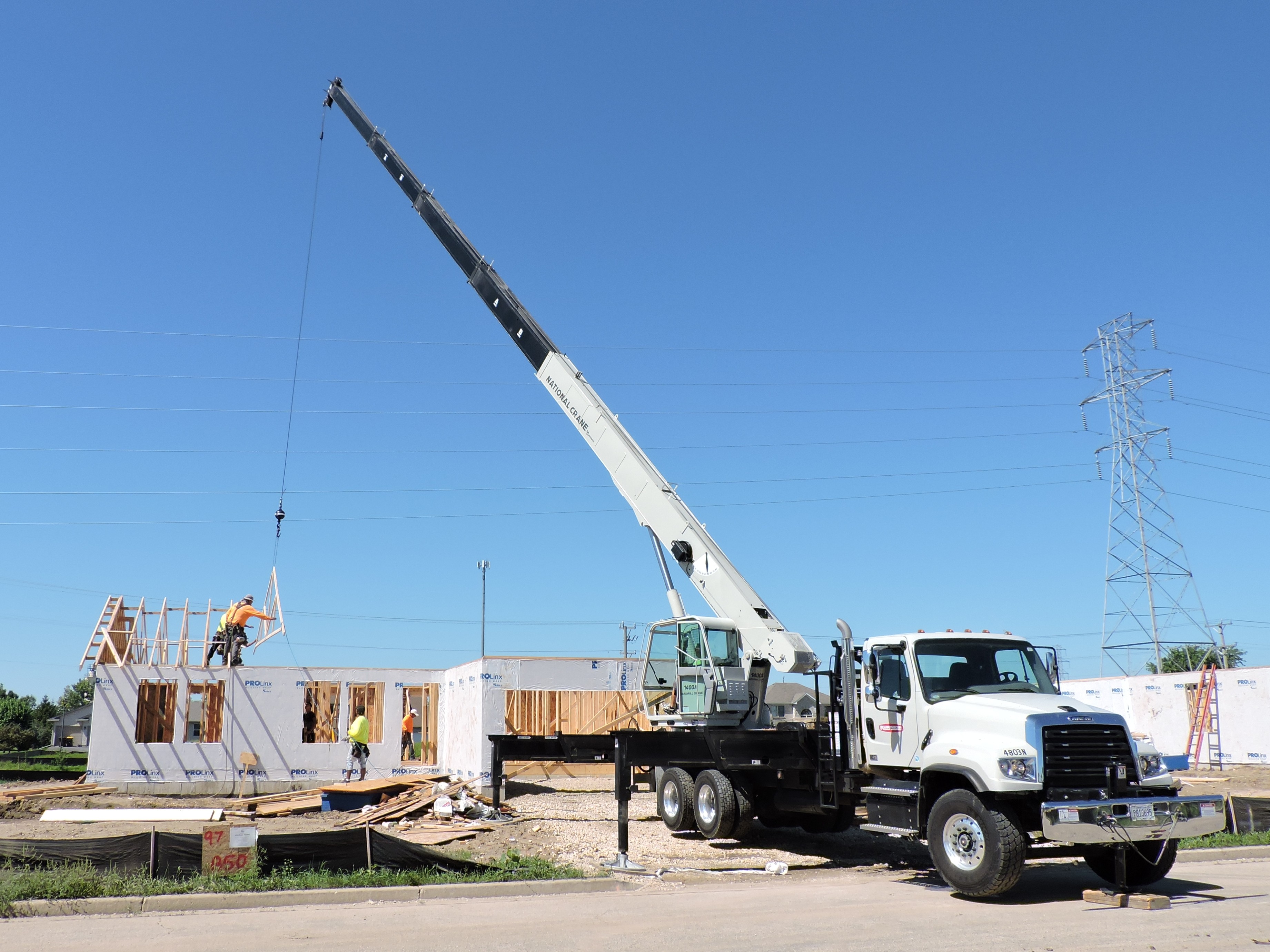 National Crane 1400A lifting trusses during a house build