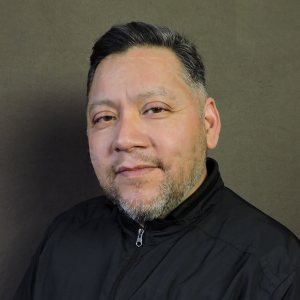 Moises Gama in black zip up shirt