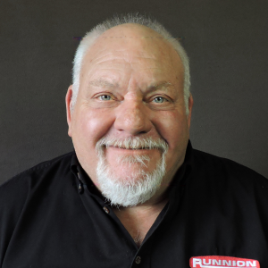 John Pielli smiling in black button up shirt