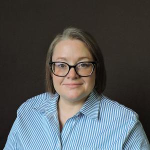 Kara in a blue and white striped shirt